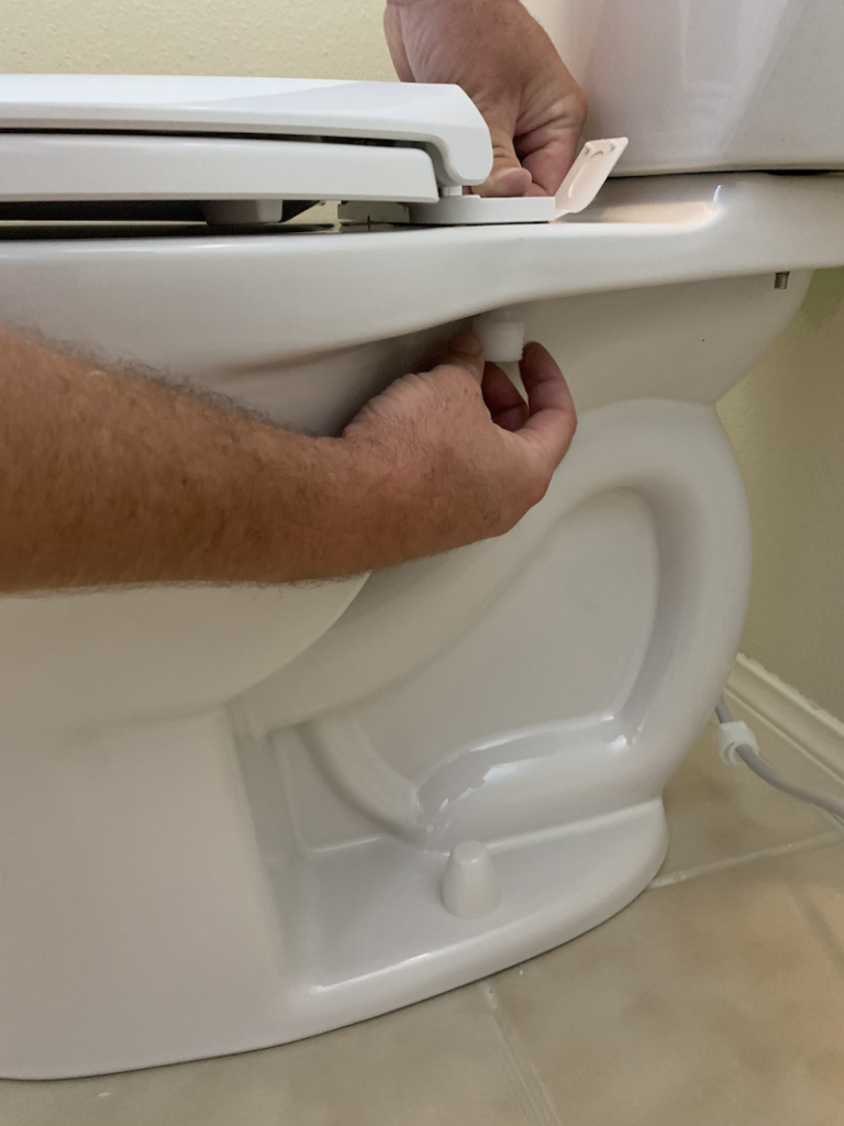How to Install a Toilet - Attach Nut to Toilet Seat