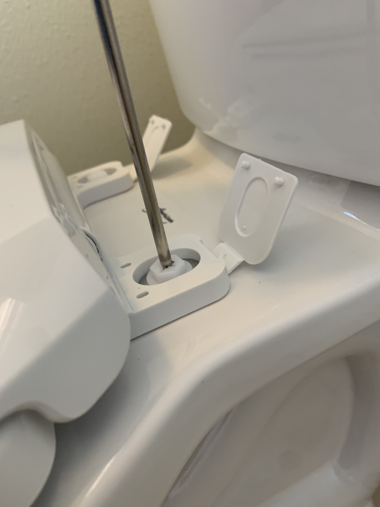 How to Install a Toilet - Tighten Toilet Seat with Screwdriver
