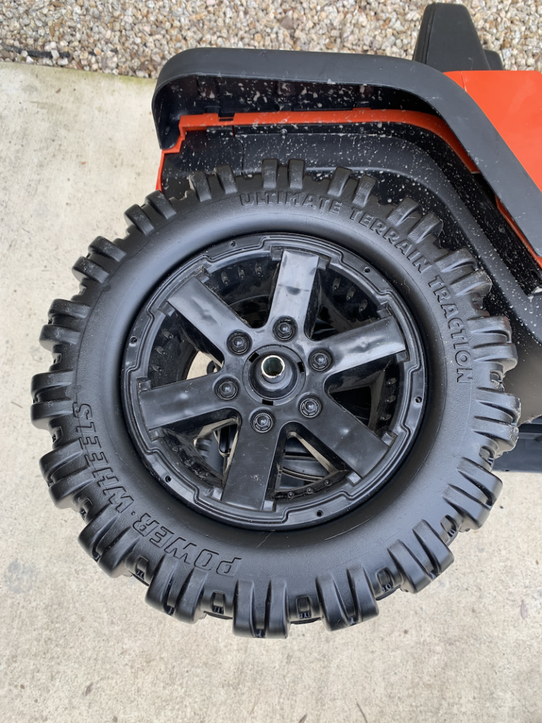 Place the tire on the power wheels axle
